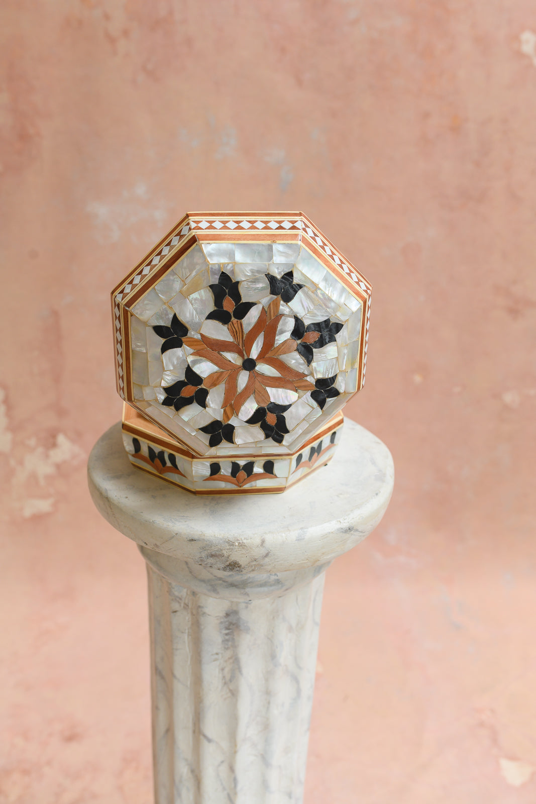 Side view of octagonal keepsake box with black and wood petal trim
