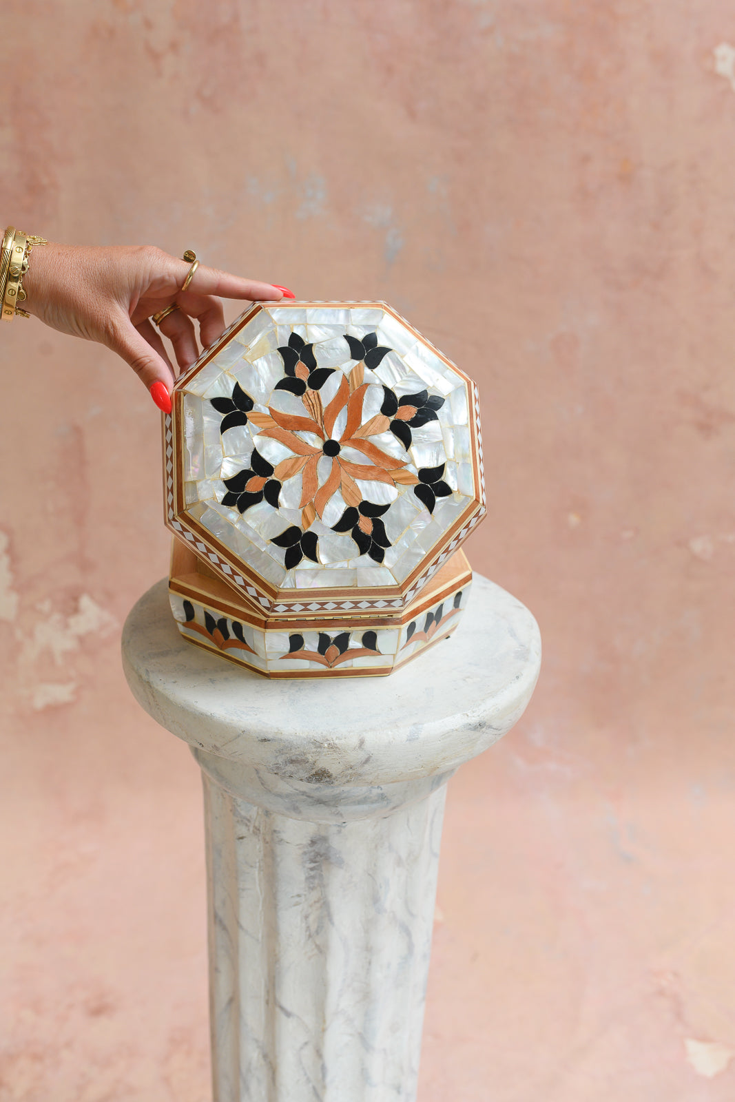 Damascus mother-of-pearl octagonal keepsake box held to show scale
