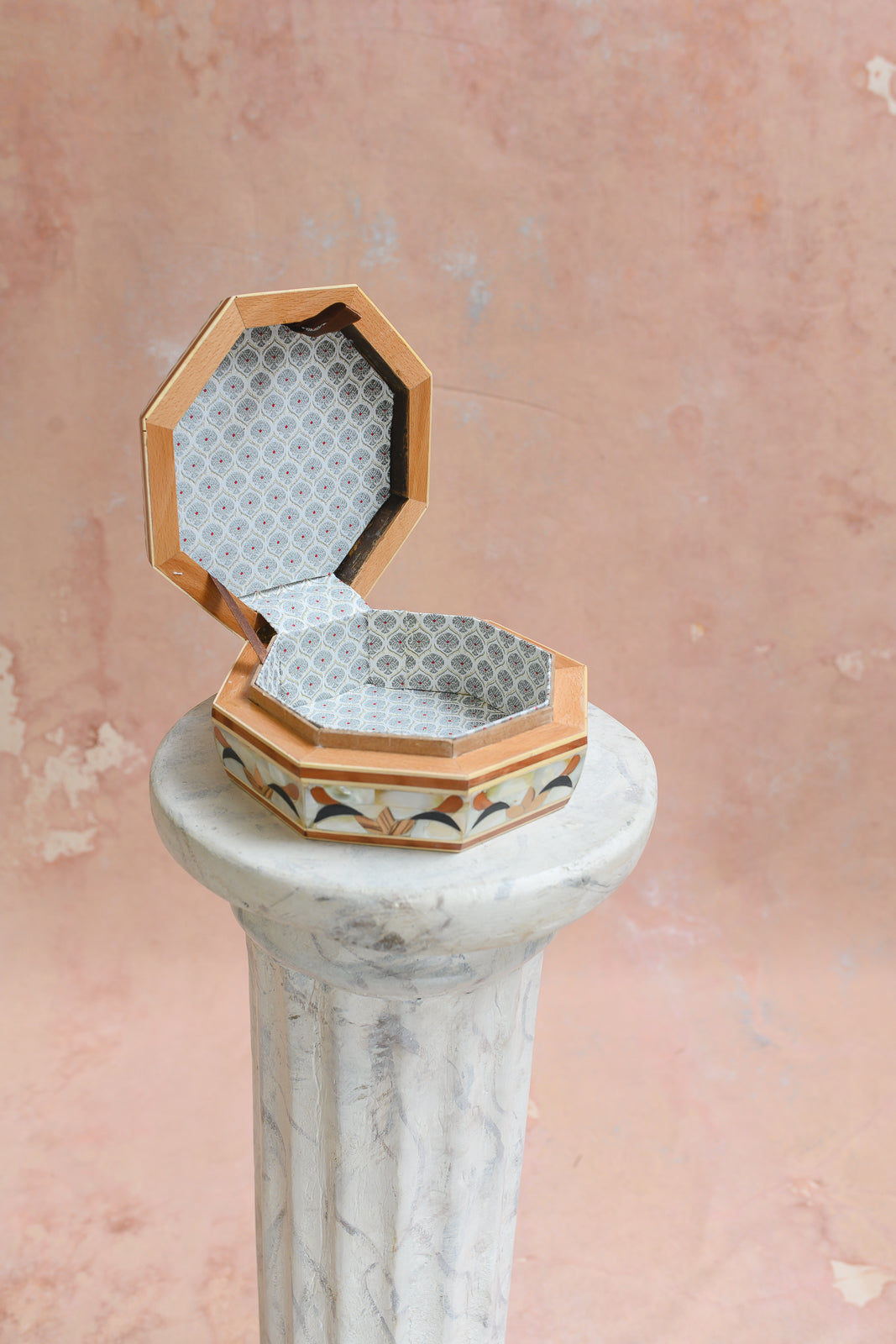 Interior of Damascus octagonal keepsake box lined in grey diamond-lattice brocade