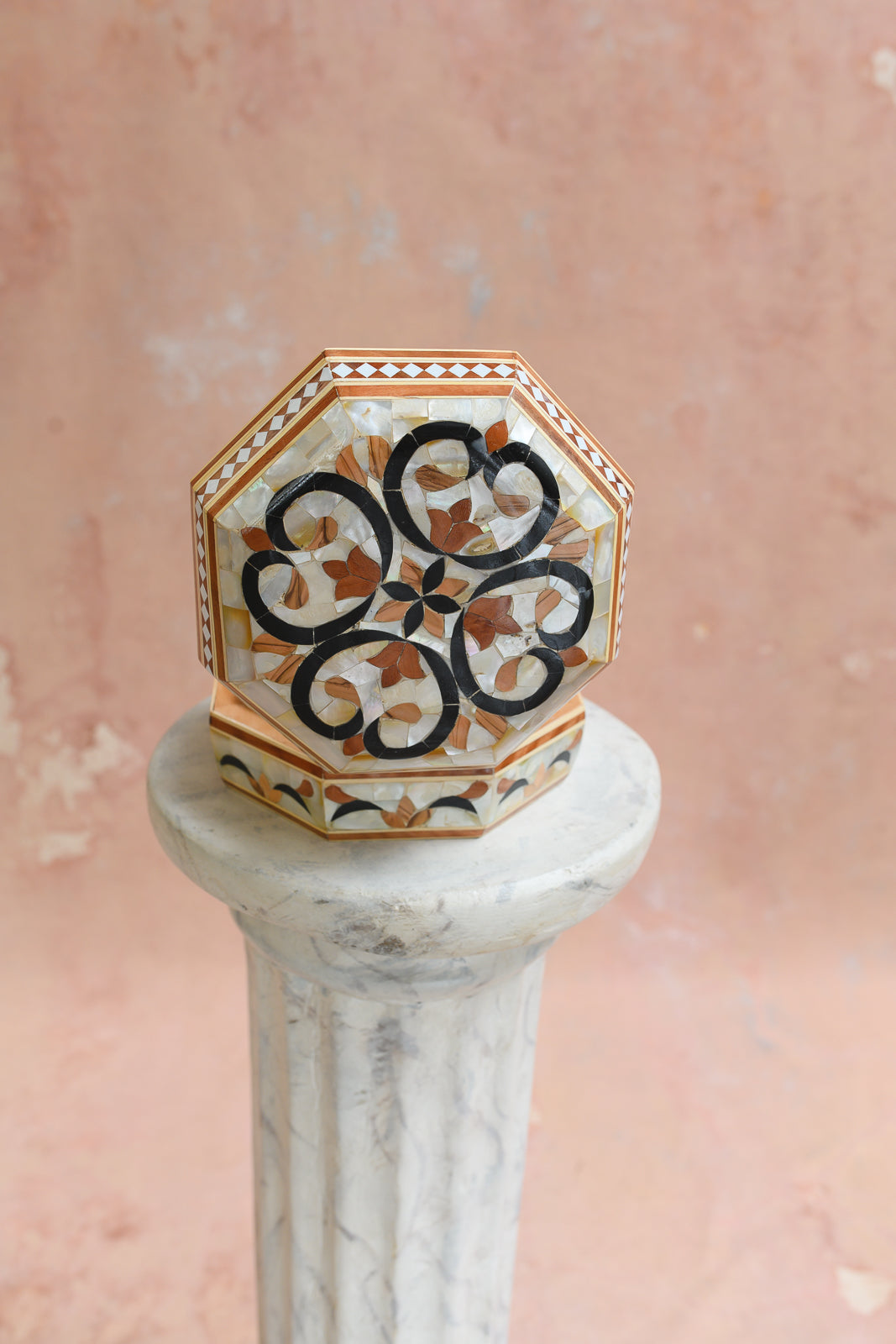 Angled view of octagonal keepsake box with black scroll medallion inlay
