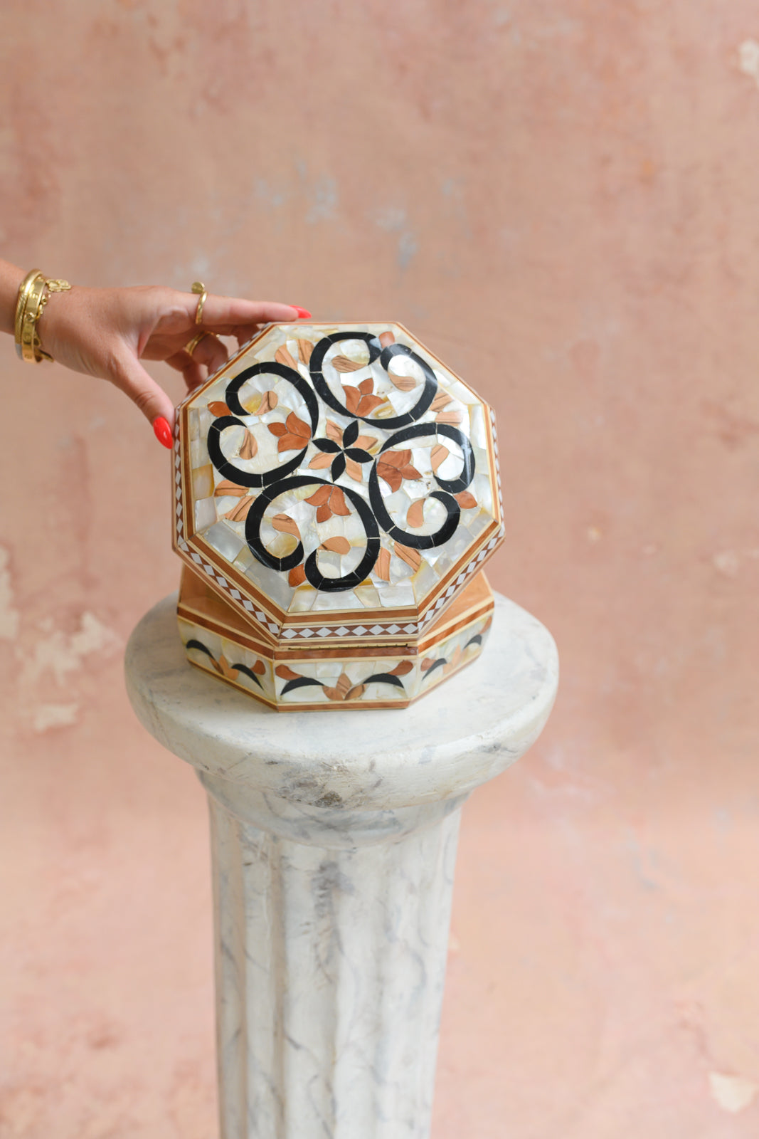 Damascus mother-of-pearl octagonal keepsake box held to show scale