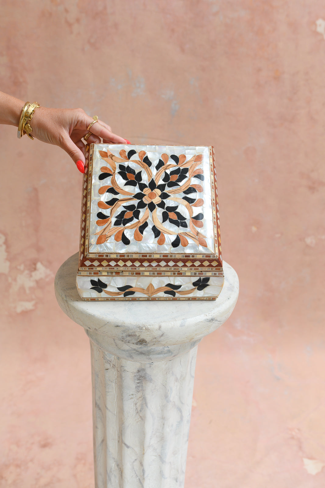 Damascus mother-of-pearl keepsake box held to show scale