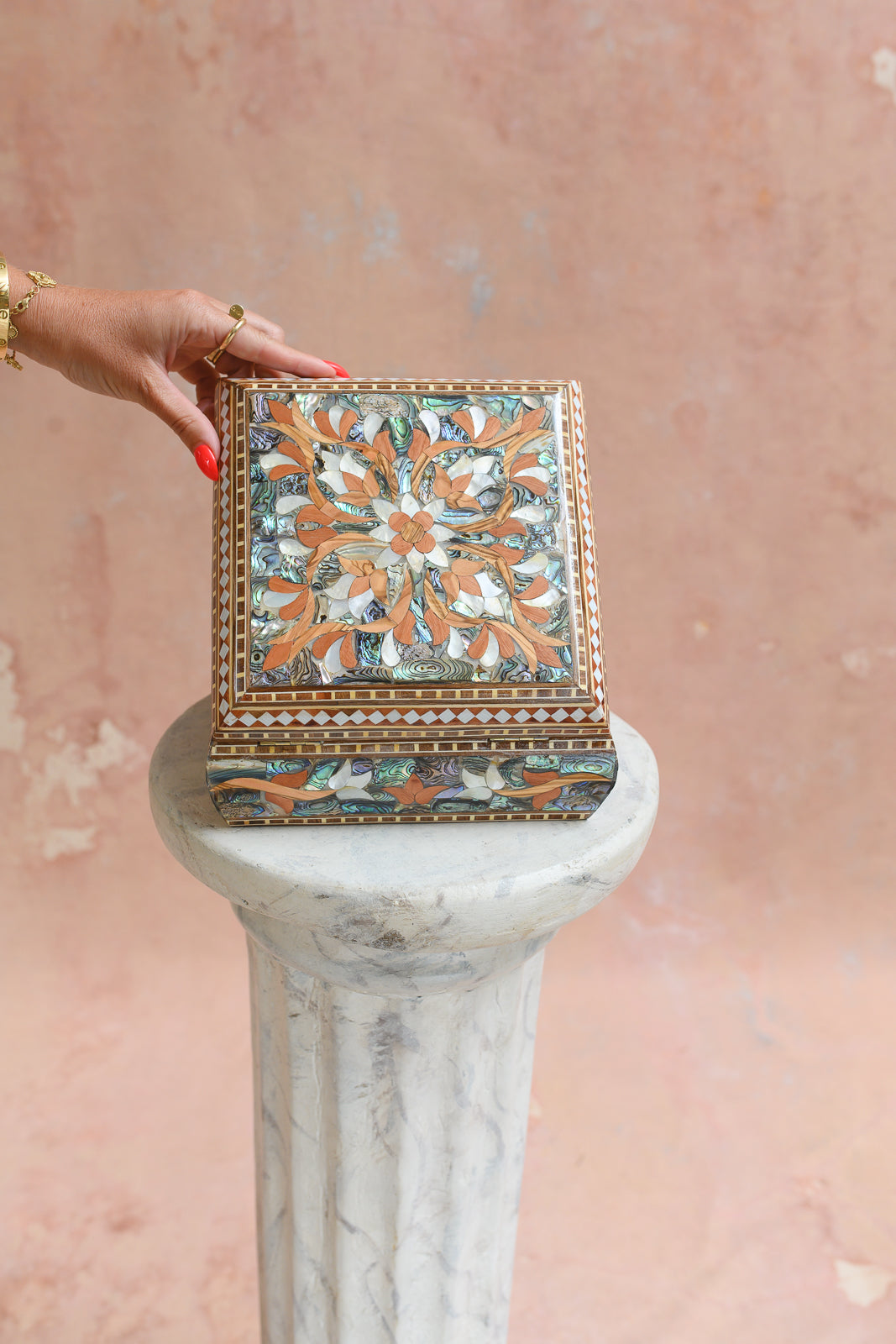 Damascus mother-of-pearl keepsake box held to show scale