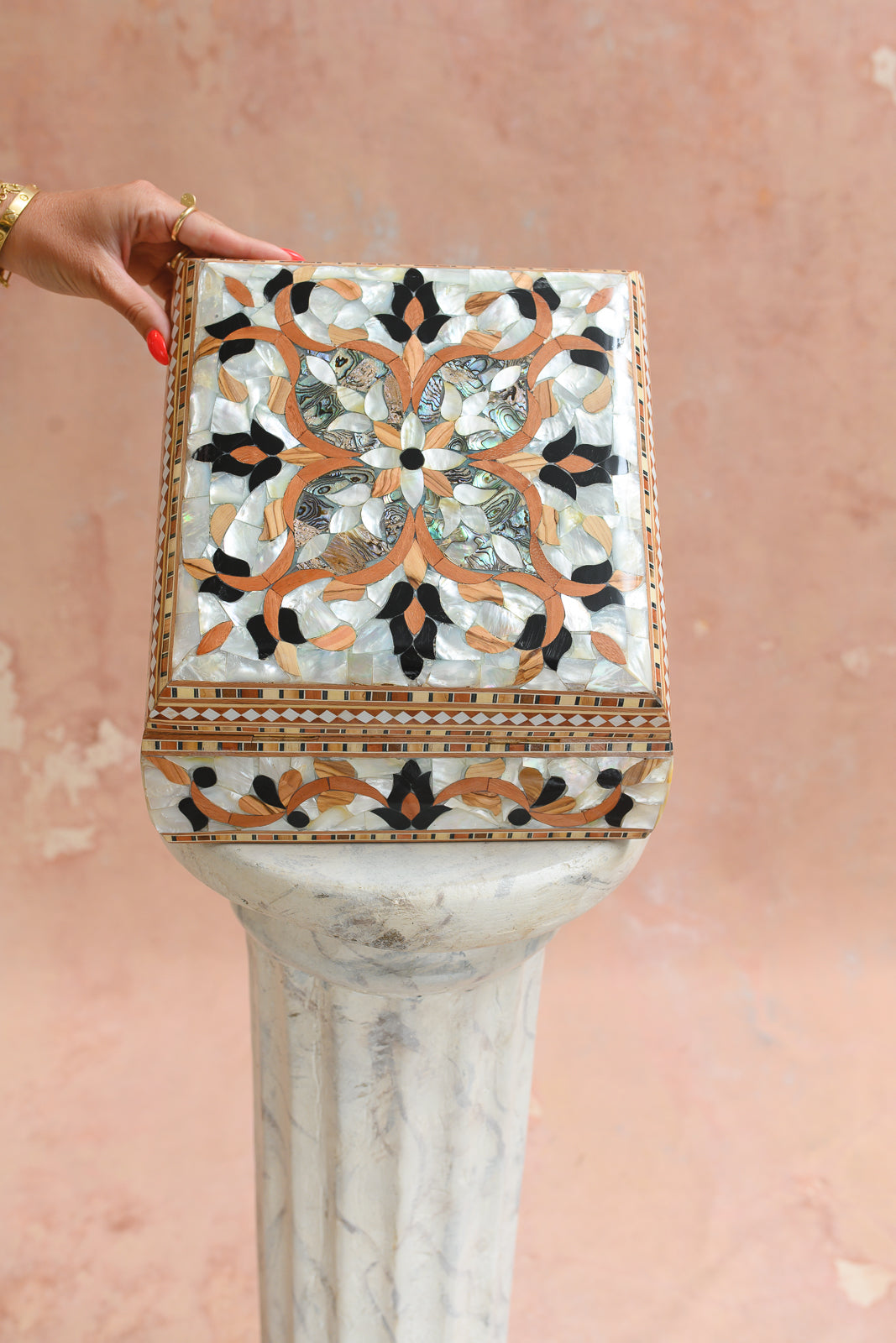 Damascus mother-of-pearl keepsake box held to show scale