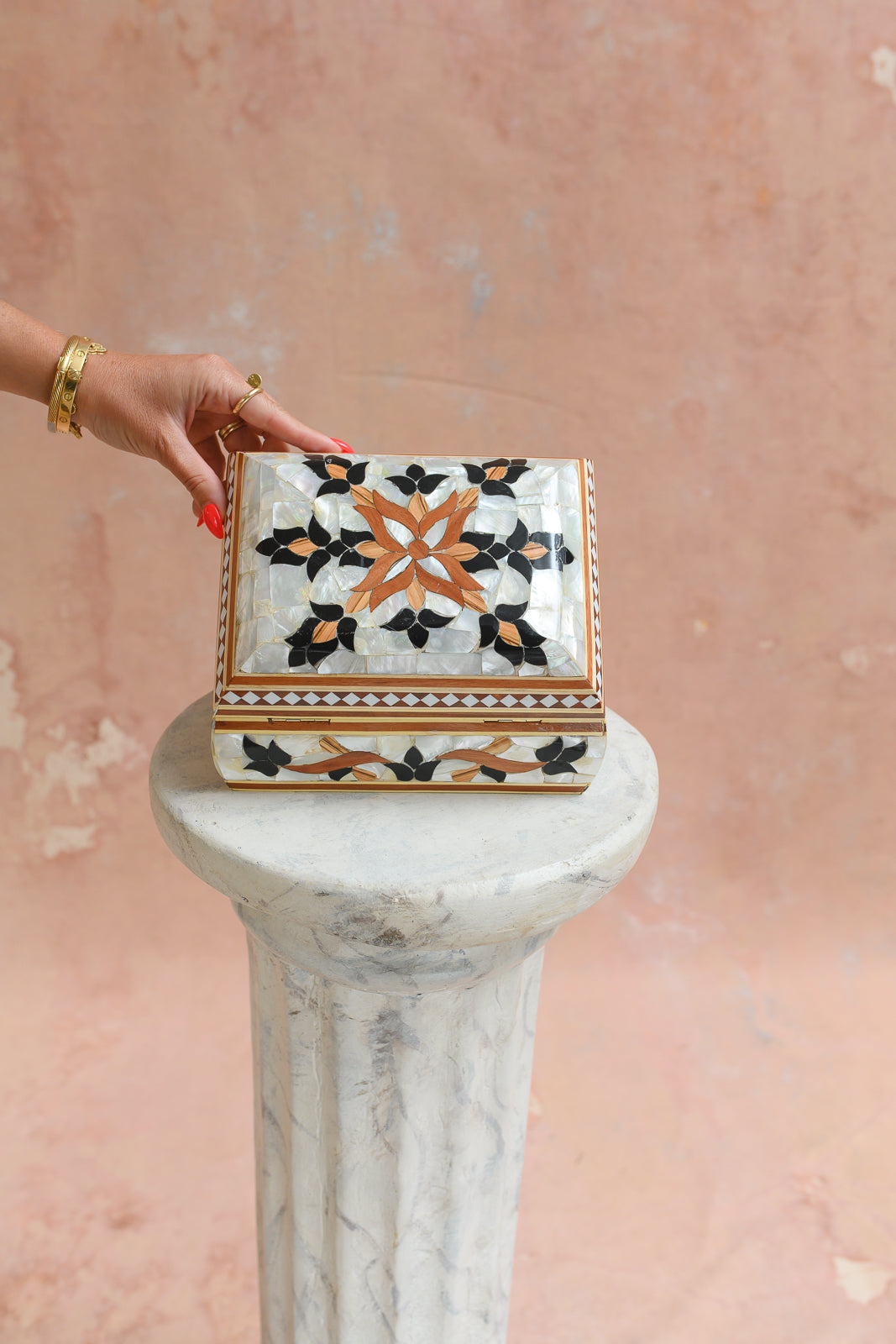 Damascus mother-of-pearl keepsake box held to show scale