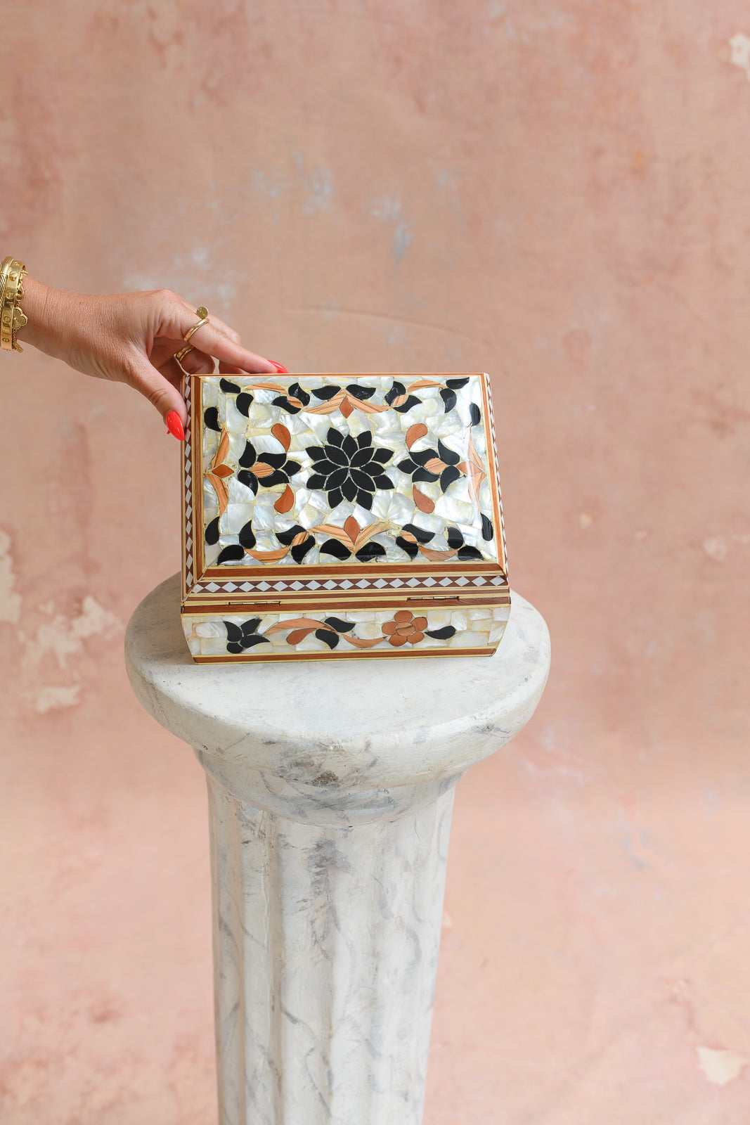 Damascus mother-of-pearl keepsake box held to show scale