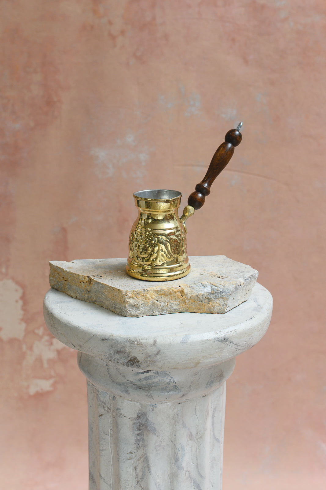 Hand-etched brass Arabic coffee pot with floral pattern and wood handle