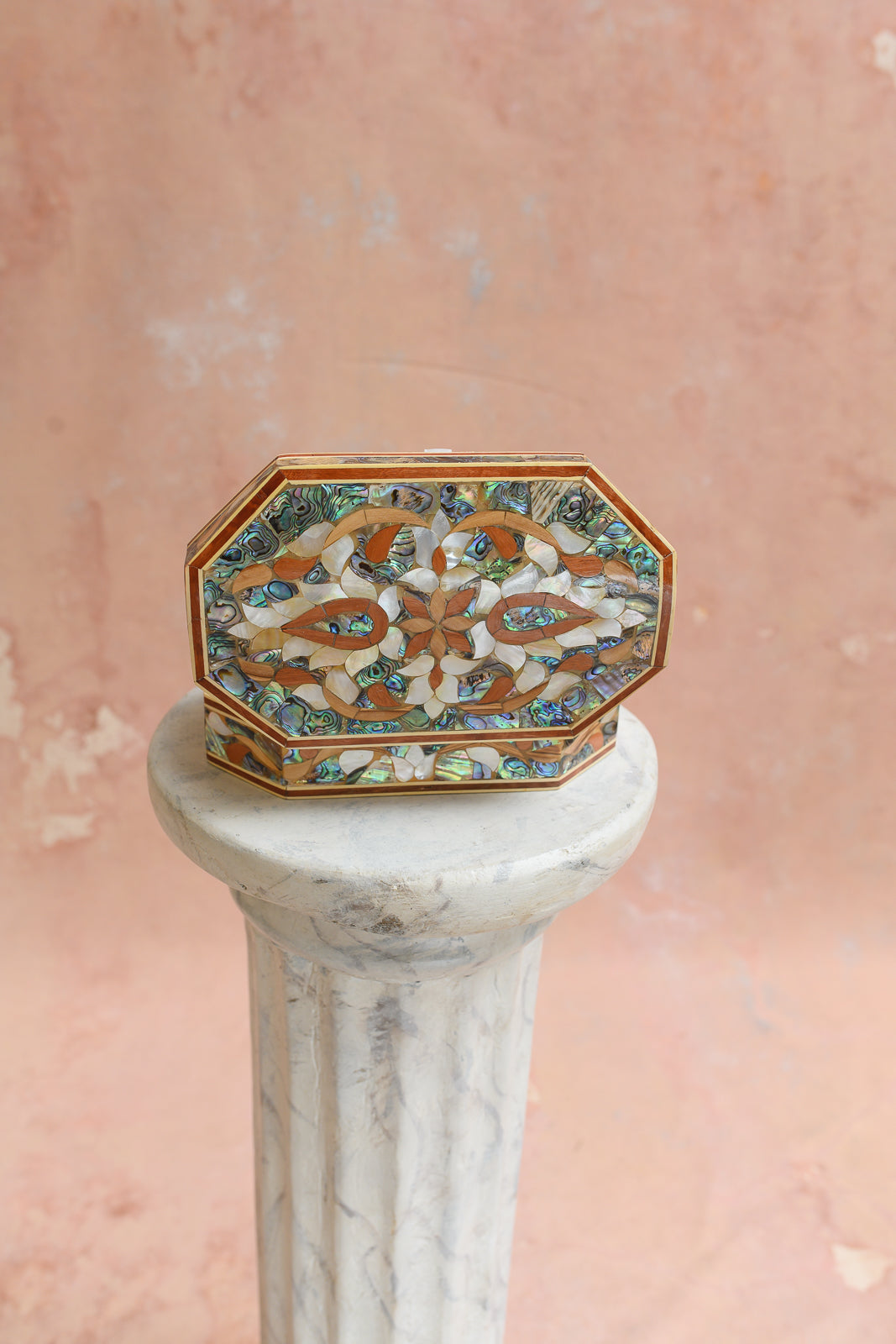 Top view of elongated abalone shell keepsake box with vine and petal inlay