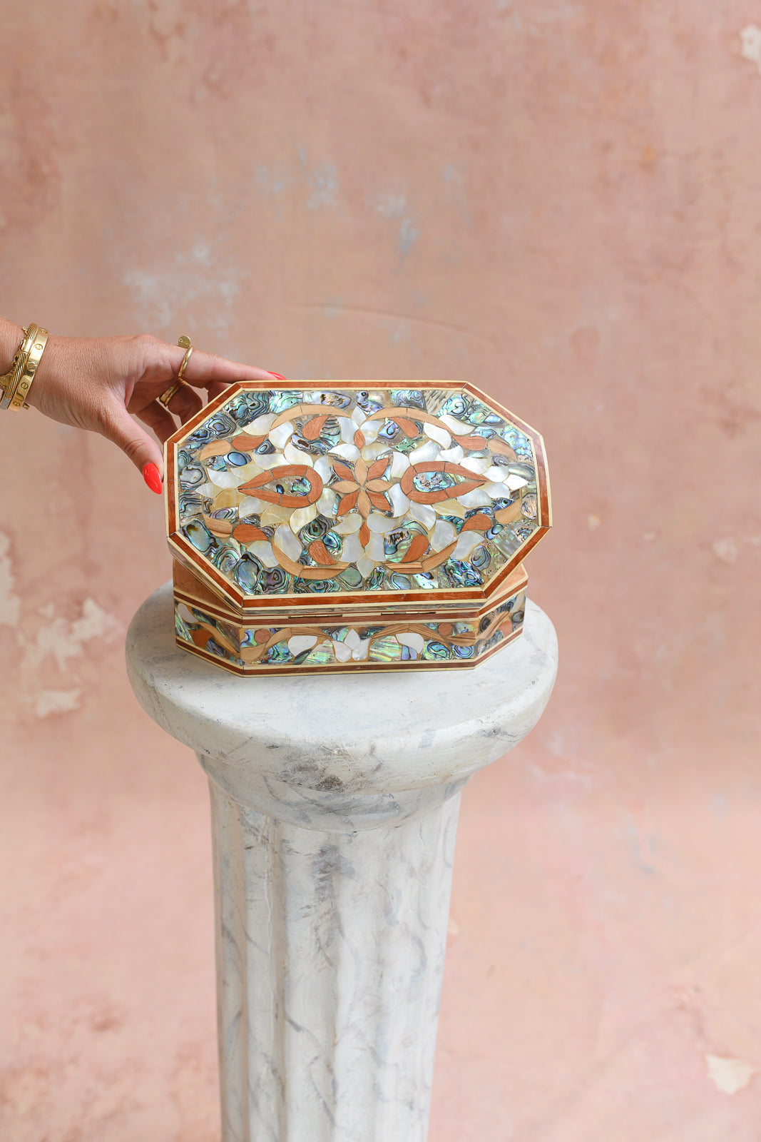 Damascus mother-of-pearl keepsake box held to show scale