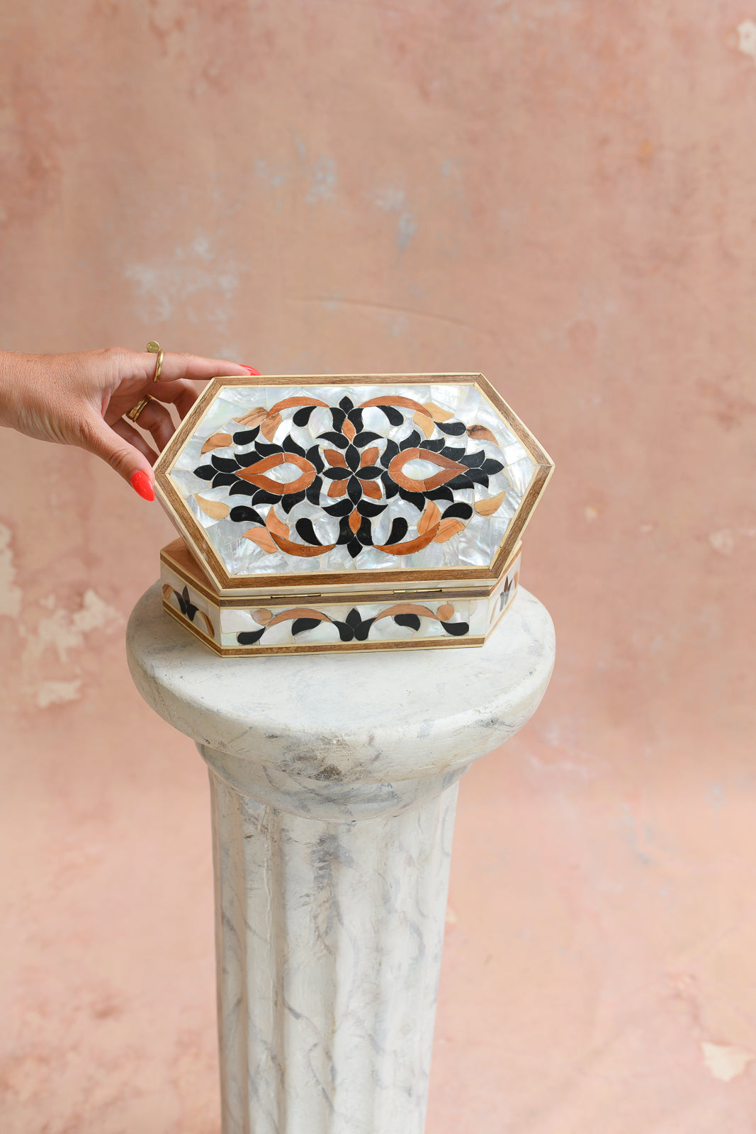 Damascus mother-of-pearl keepsake box held to show scale