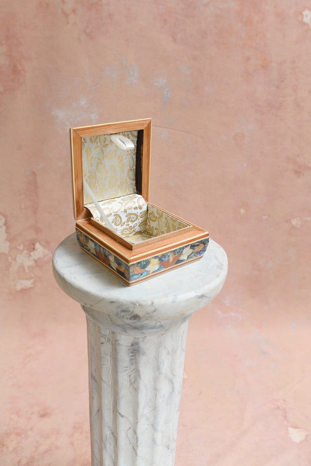 Interior of Damascus keepsake box lined in gold paisley-print brocade
