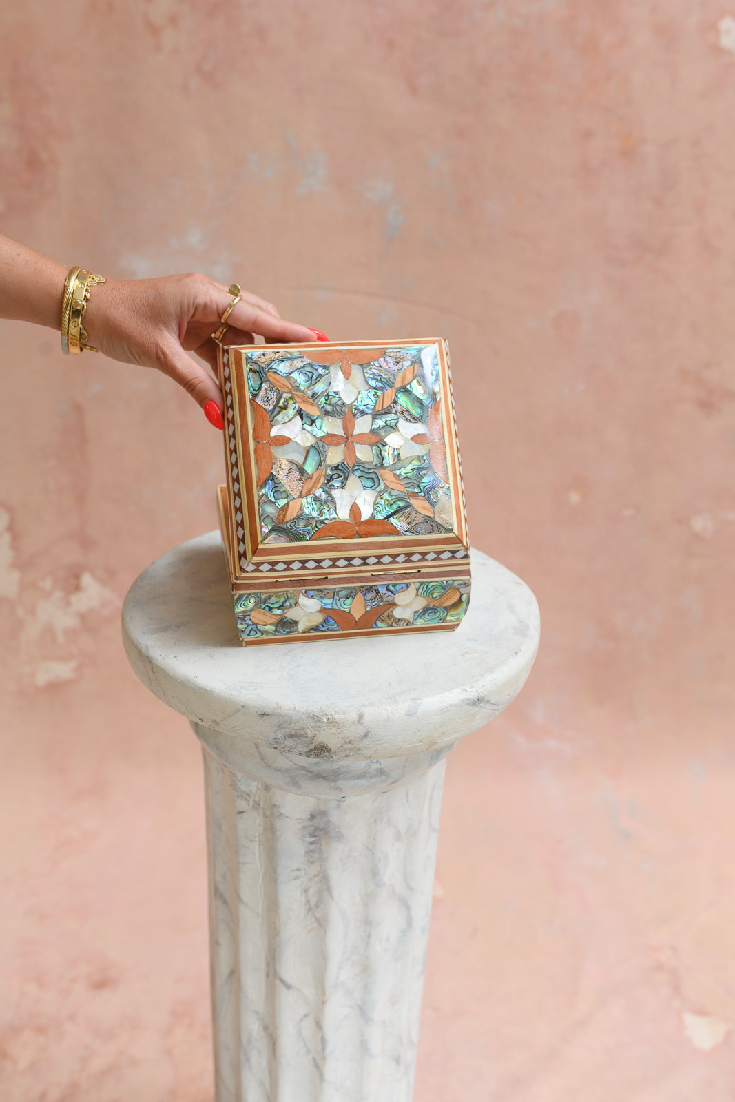 Damascus mother-of-pearl keepsake box held to show scale