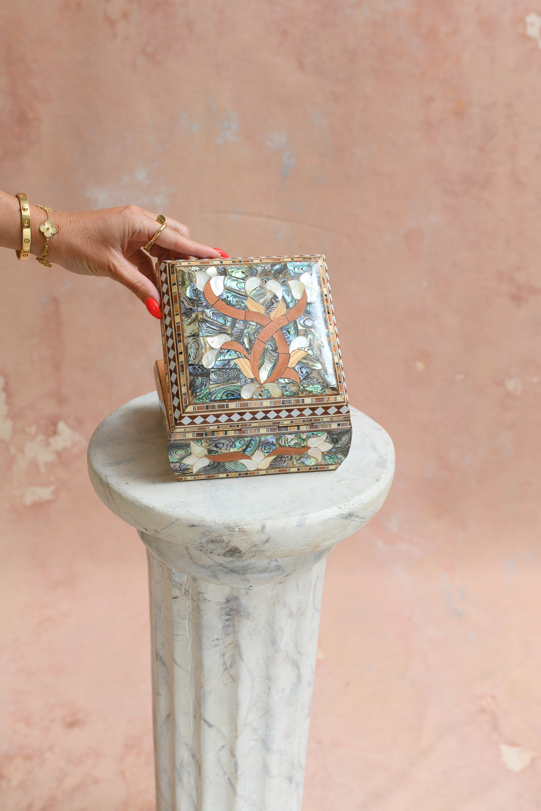Damascus mother-of-pearl keepsake box held to show scale
