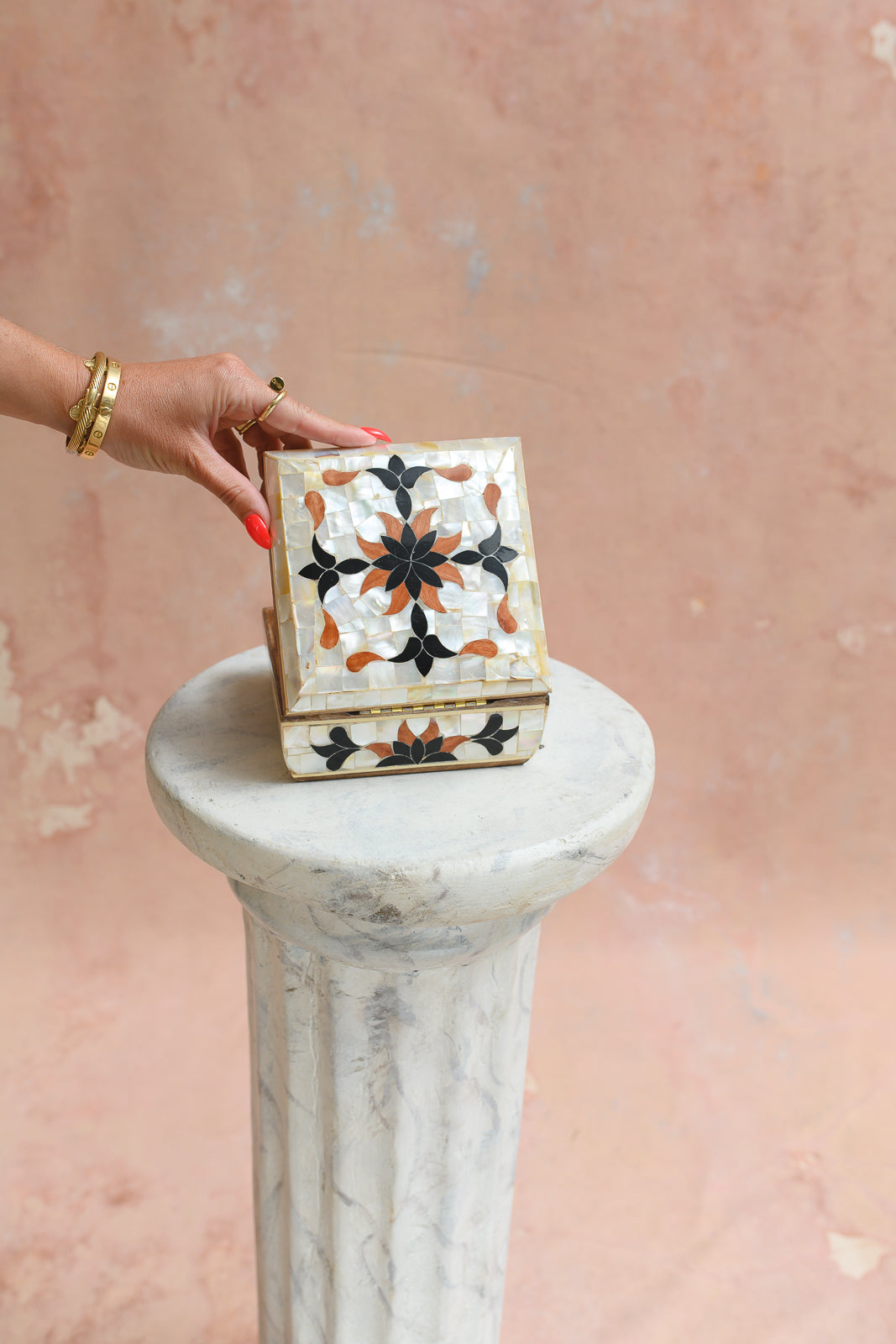 Damascus mother-of-pearl keepsake box held to show scale