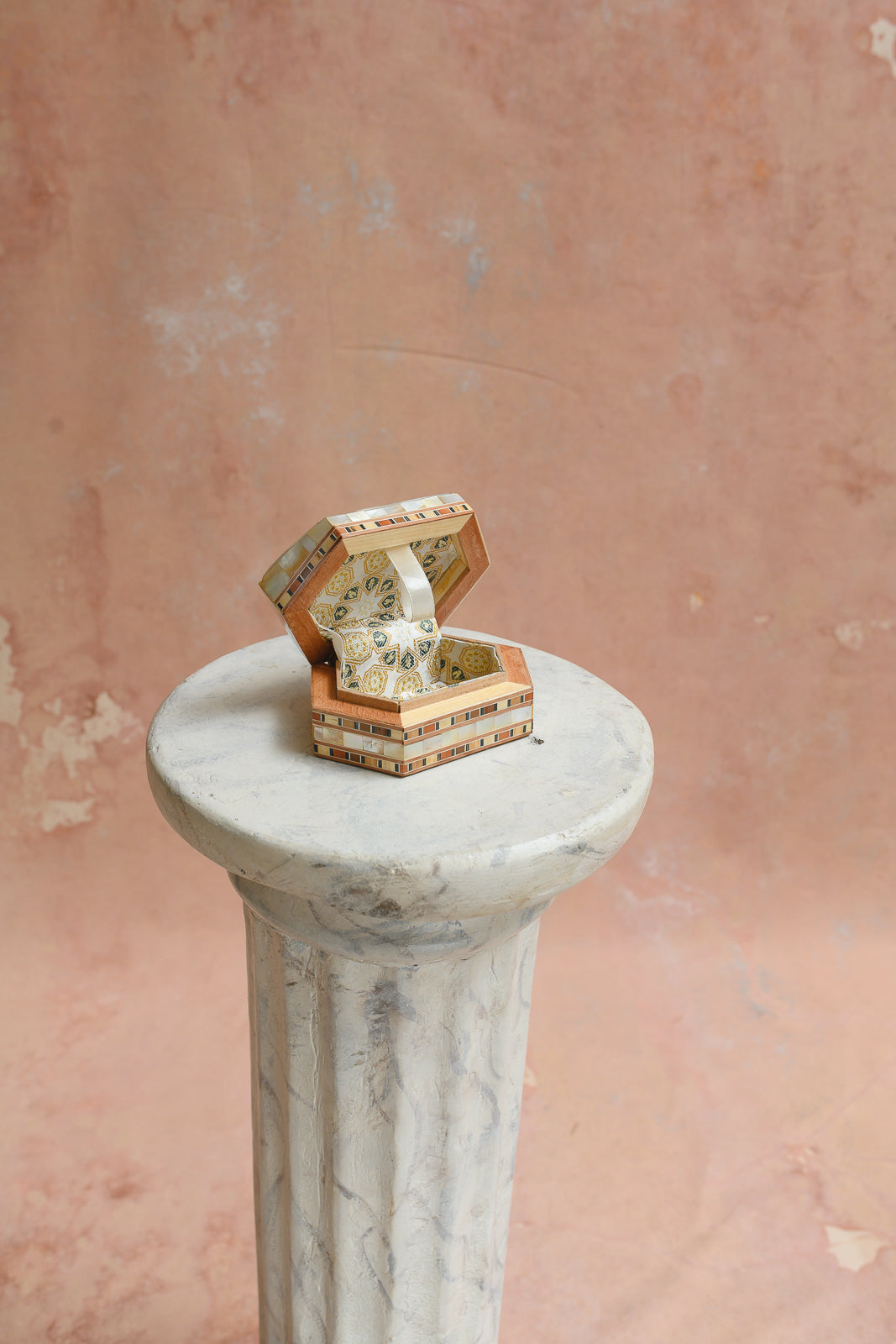 Interior of Damascus hexagon keepsake box lined in gold medallion brocade