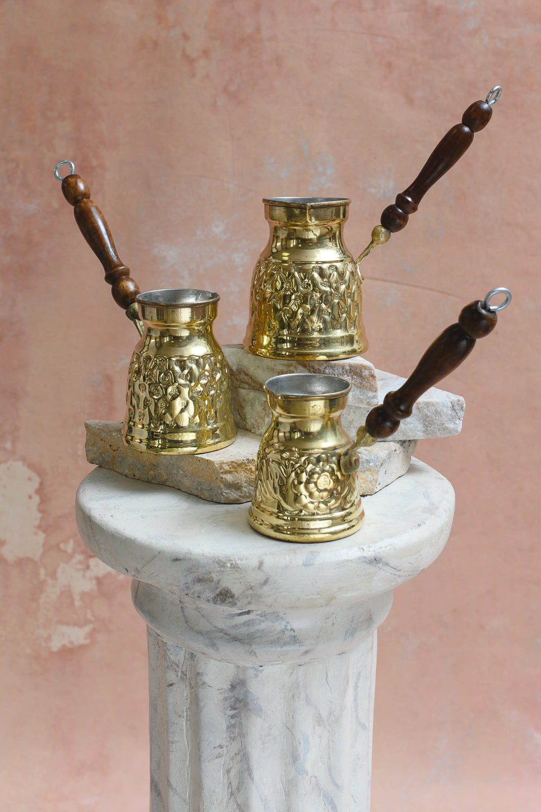 Three brass Damascus coffee pots of graduated sizes shown together for scale