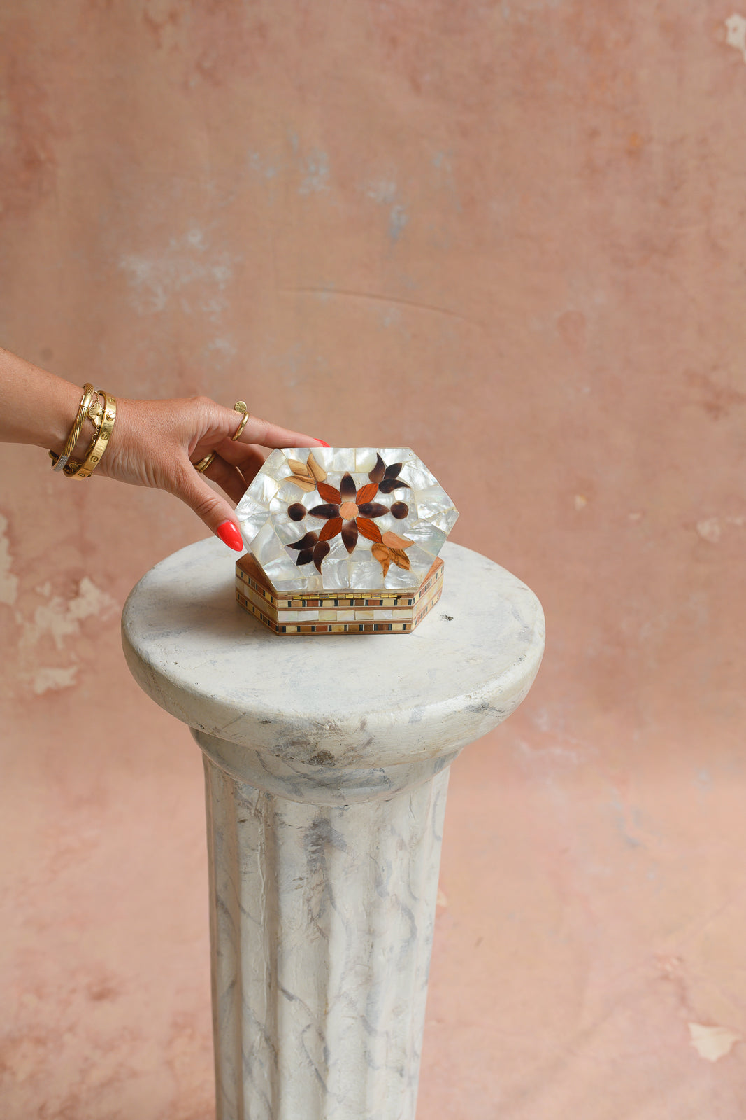 Damascus mother-of-pearl hexagon keepsake box held to show scale