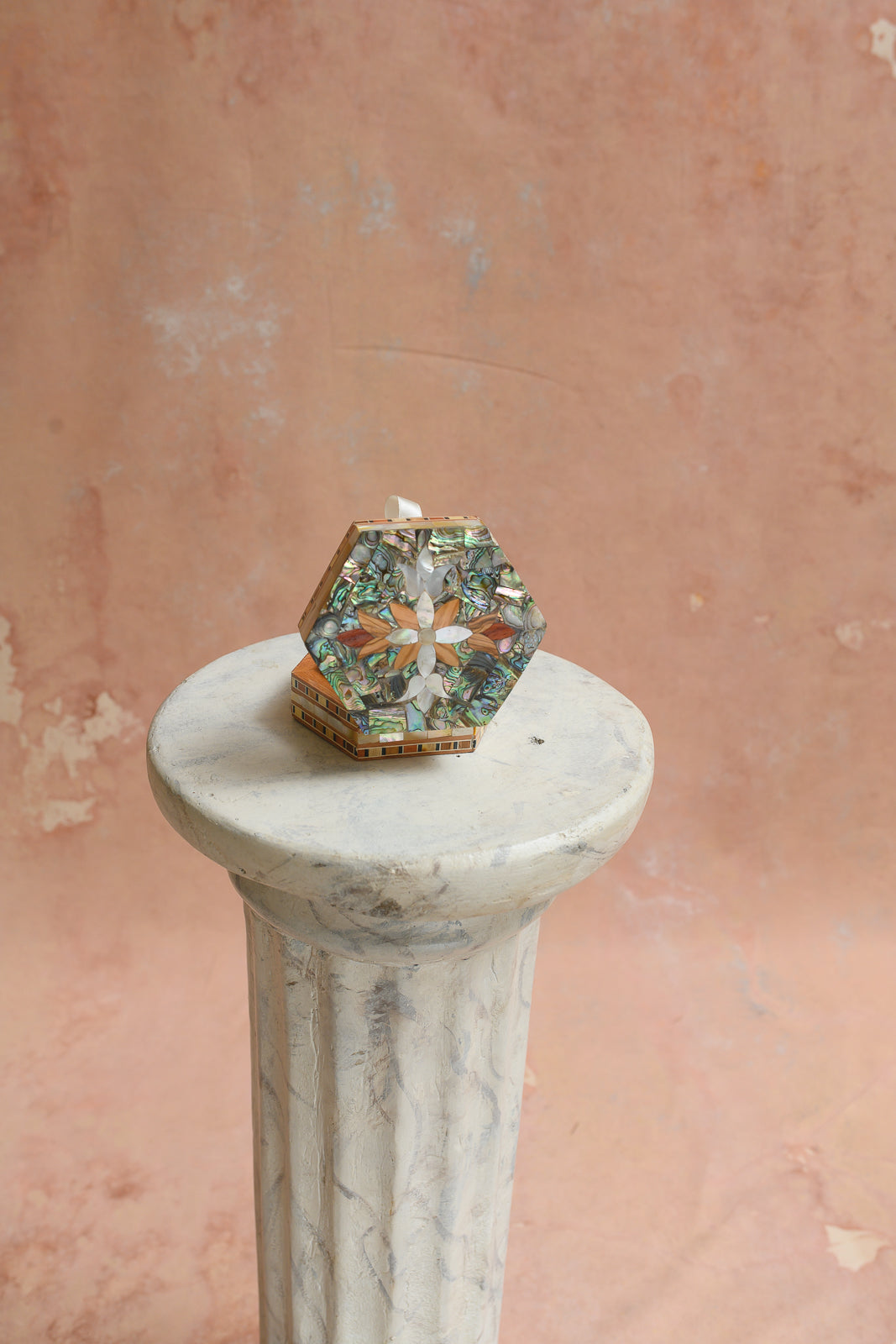 Top view of hexagon abalone keepsake box with mother-of-pearl flower medallion