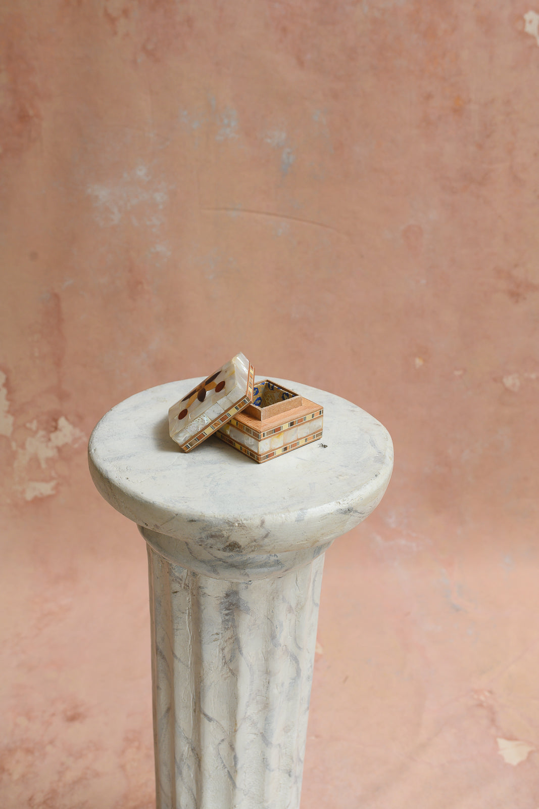Damascus ring box with lid lifted off, showing mother-of-pearl inlay