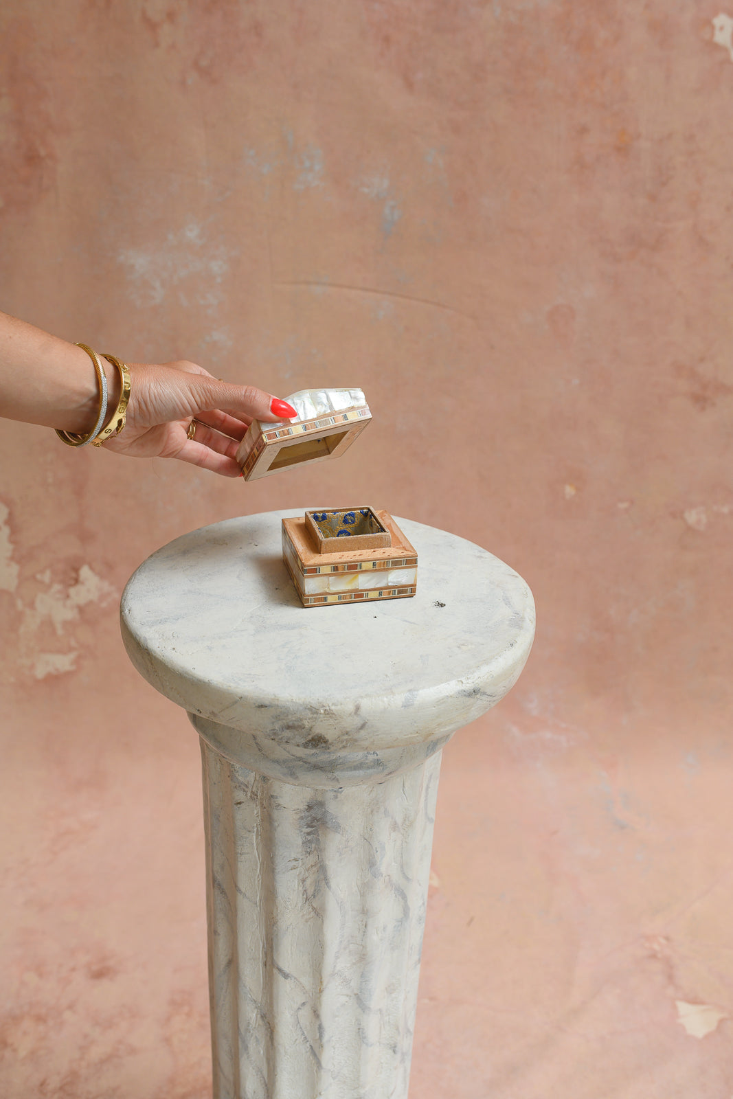 Damascus mother-of-pearl ring box held to show scale