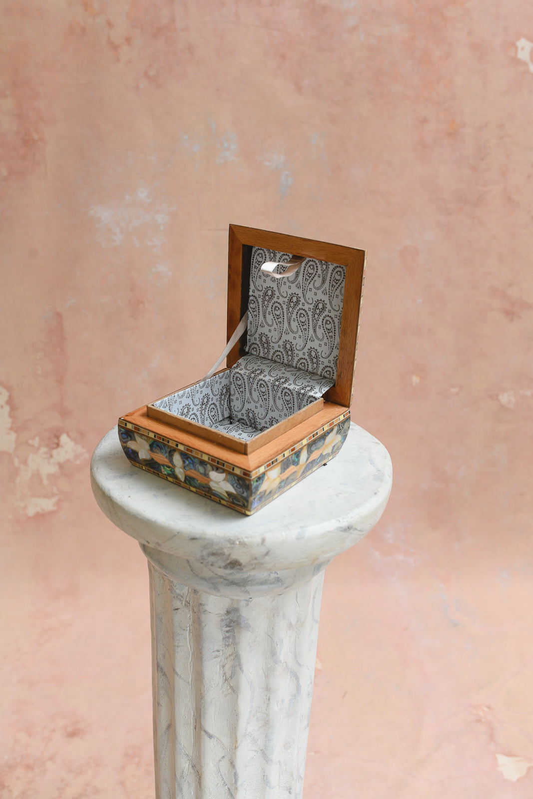 Interior of Damascus keepsake box lined in cream paisley-print brocade