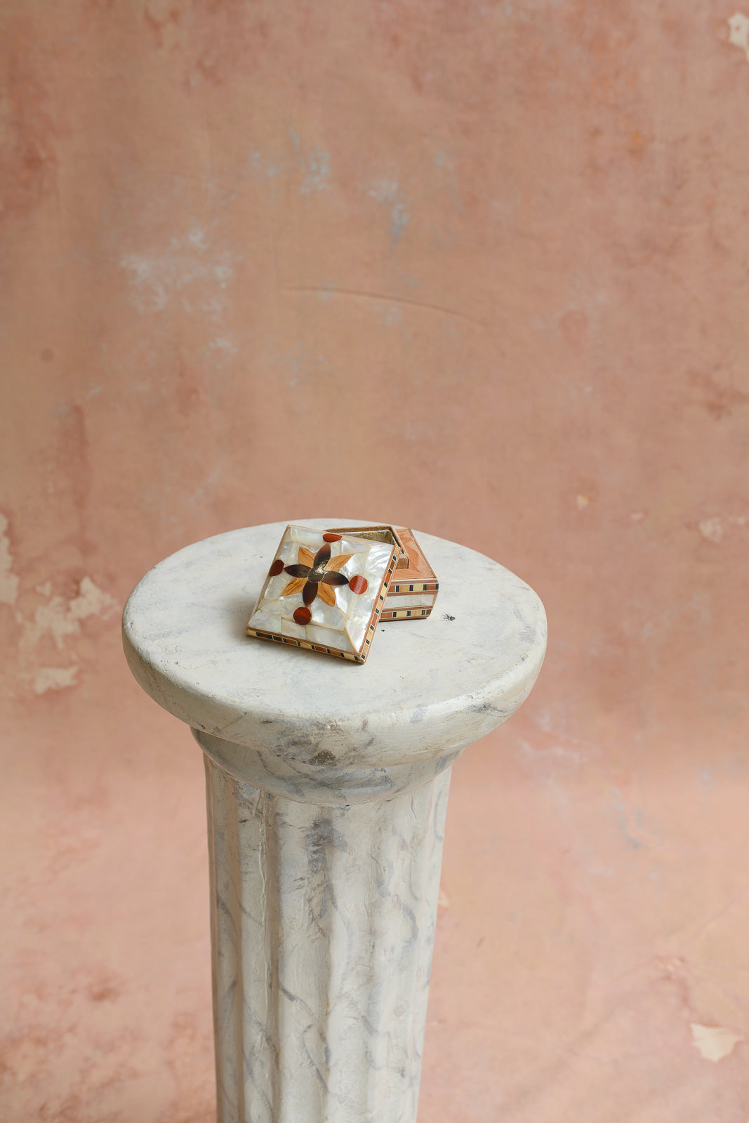 Damascus ring box with lid lifted off, showing gold medallion lining