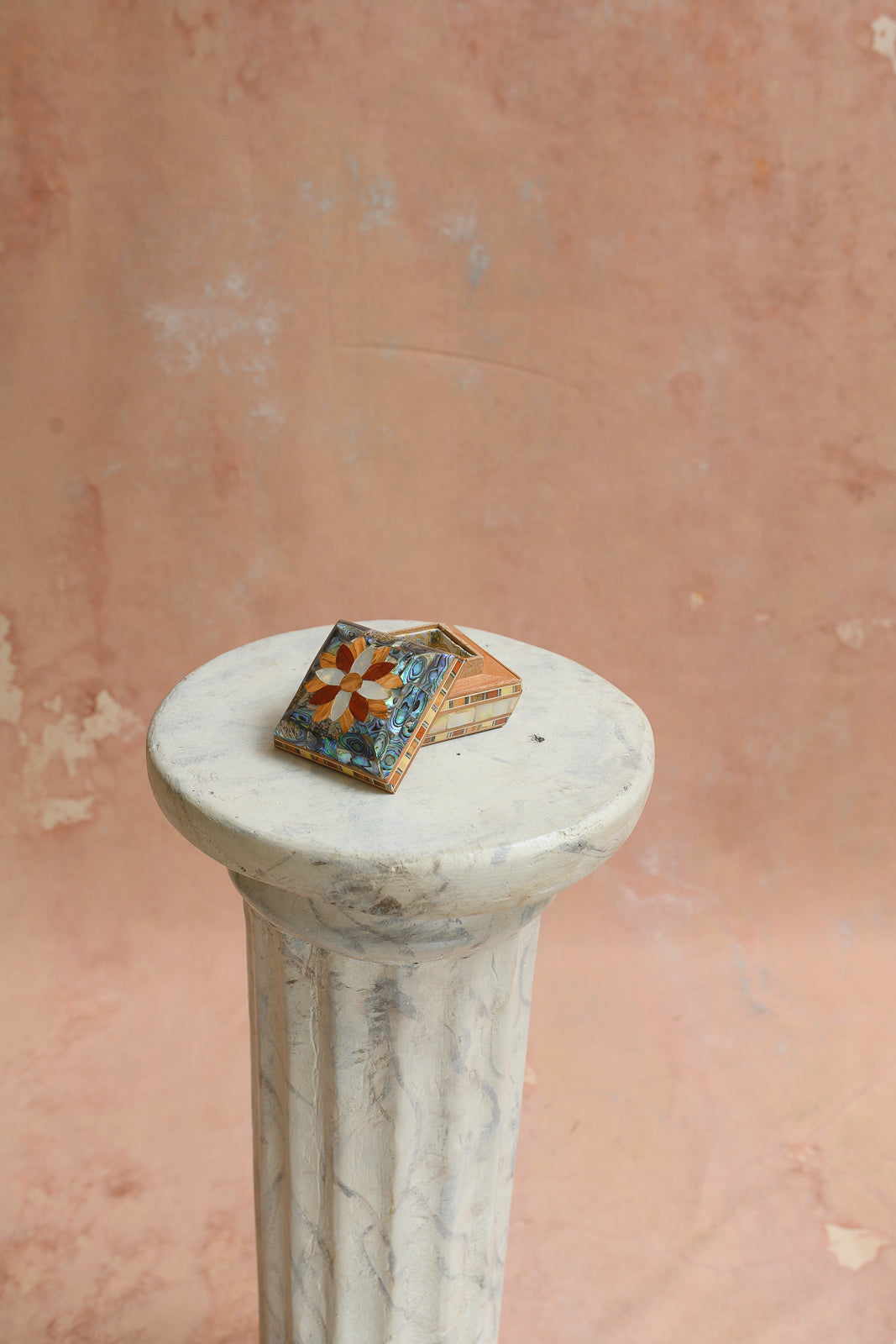 Angled view of Damascus abalone ring box with wood flower medallion