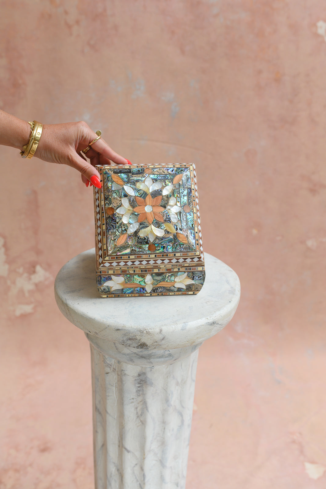 Damascus mother-of-pearl keepsake box held to show scale
