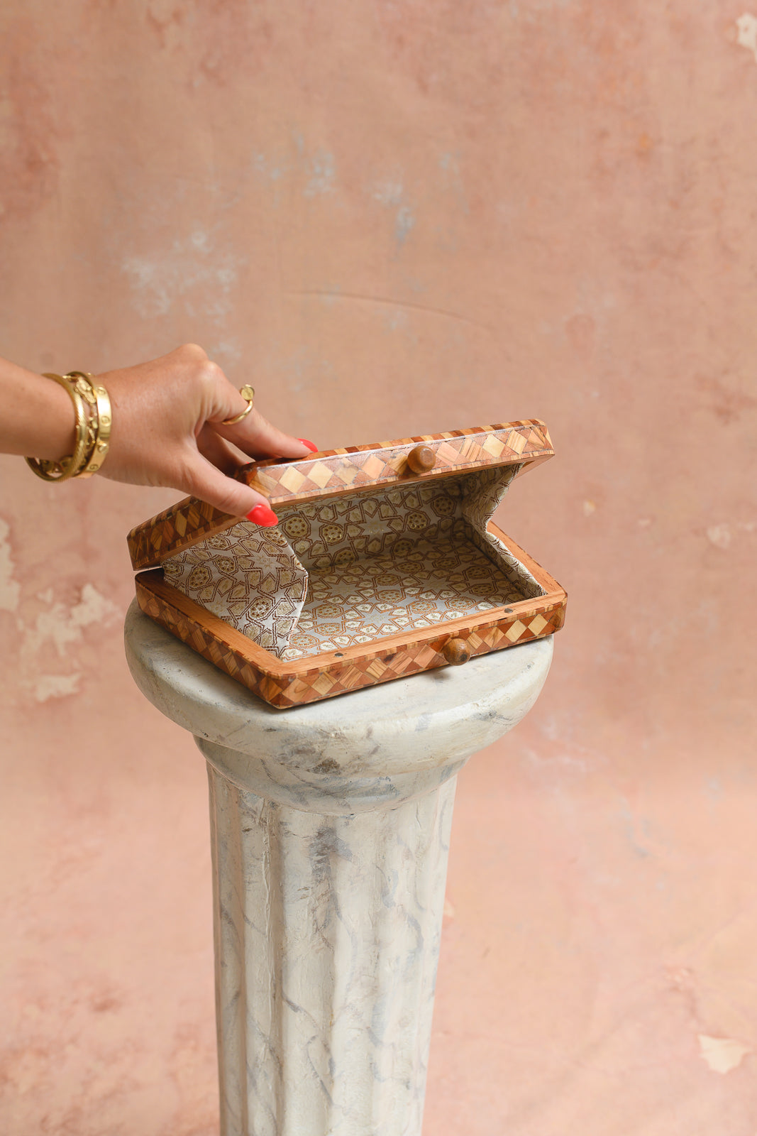 Interior of Damascus box clutch lined in ivory and gold star-pattern brocade