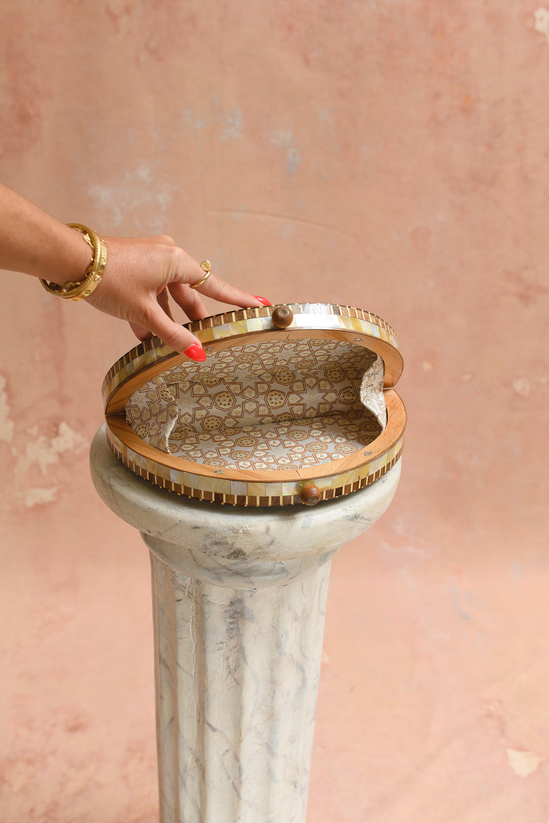 Interior of Damascus half-moon clutch lined in ivory and gold star-pattern brocade