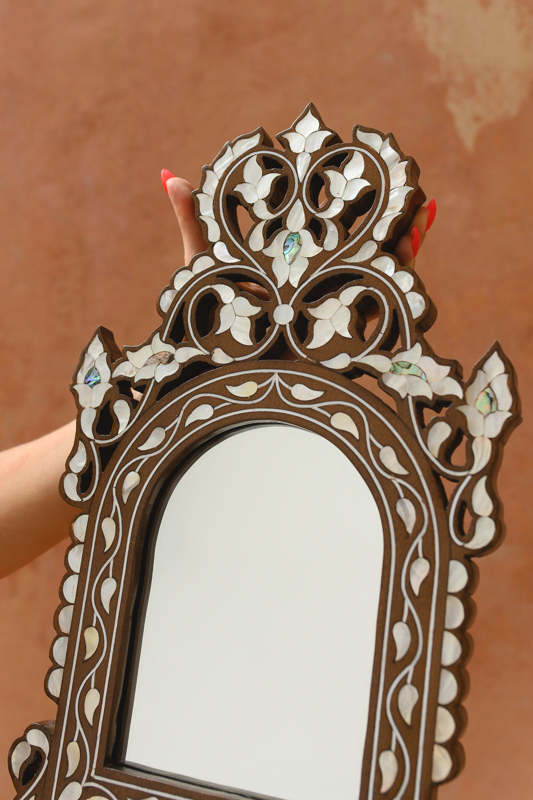 Detail of pierced fretwork crown with mother-of-pearl petals and abalone accents