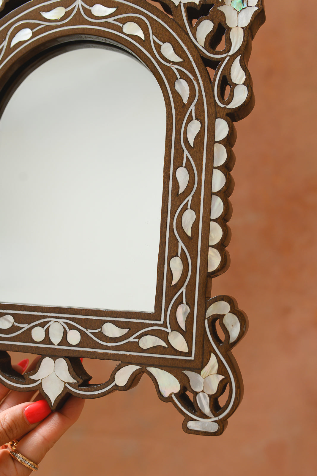 Close-up of mother-of-pearl fretwork crown on Damascus arched mirro