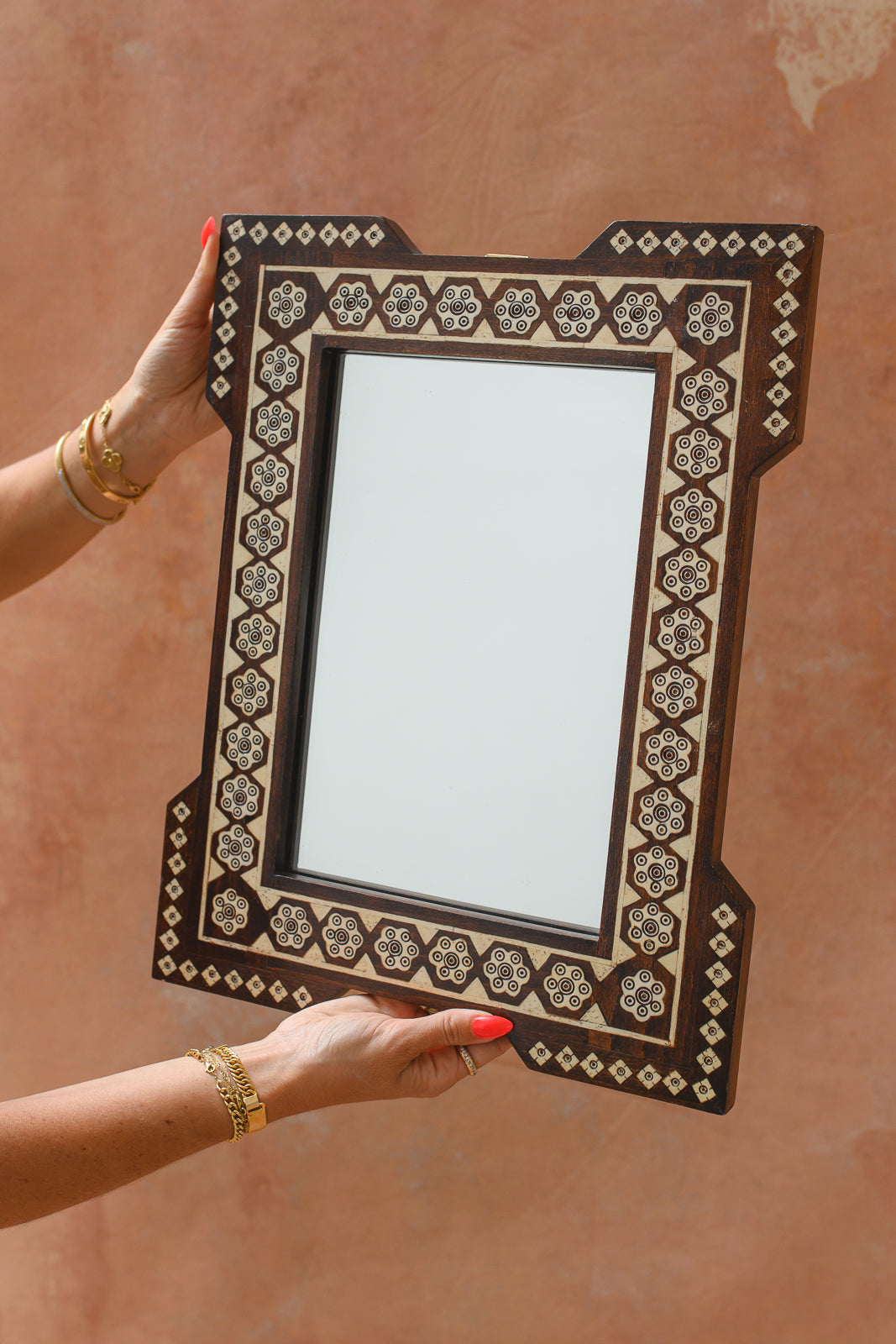 Damascus bone inlay wall mirror with hexagon rosette pattern, held up