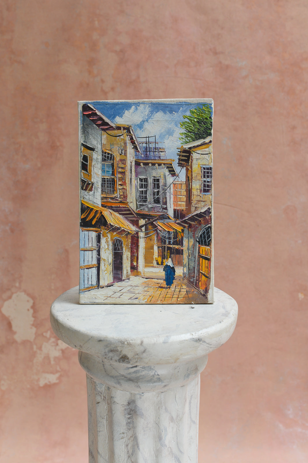 Original oil painting of a figure walking a Damascus alley beneath yellow awnings by a Syrian artist